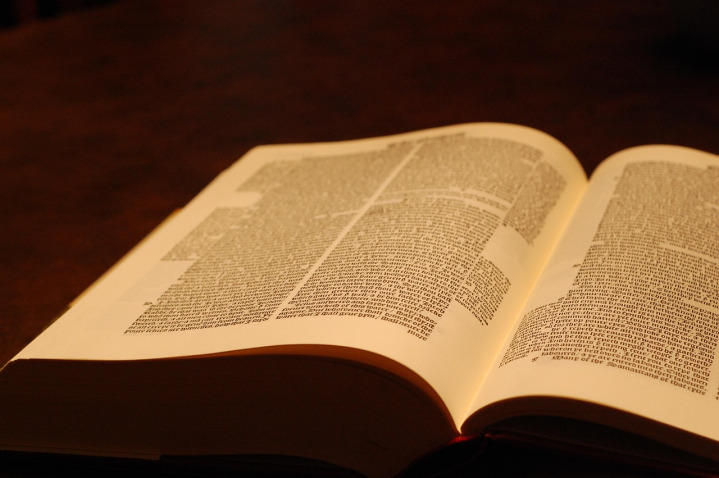 Open Bible on wooden pews